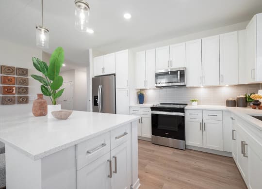 a kitchen with white cabinets and a white counter top