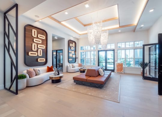 a living room with a large couch and a chandelier