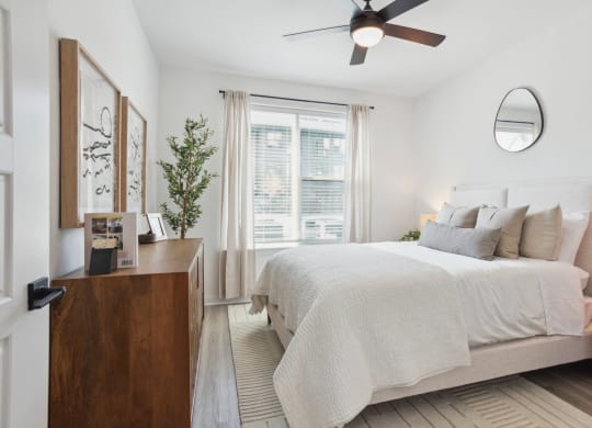 a bedroom with a large bed and a ceiling fan at Alta City Side, Nashville, Tennessee