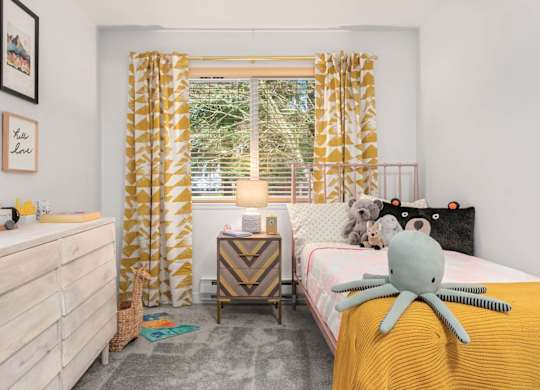Childs bedroom with yellow accents and stuffed animals at Scout Apartments, Kirkland, 98034