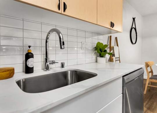 Modern kitchen with white countertops and subway tile backsplash at Scout Apartments, Kirkland, Washington
