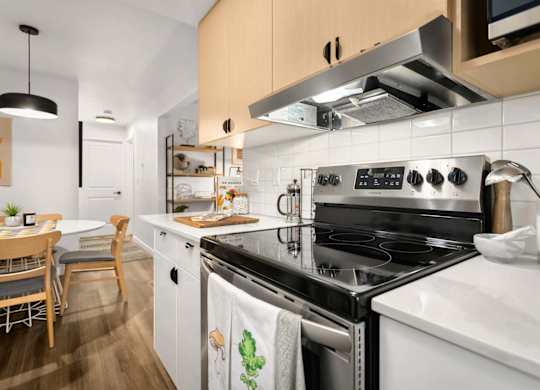 Modern kitchen with stove and range hood at Scout Apartments, Kirkland