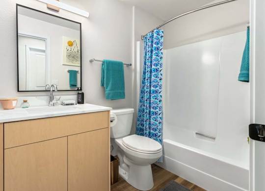 Bathroom with white shower tub and geometric curtain at Scout Apartments, Kirkland, WA 98034