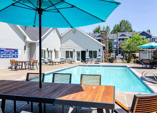 Poolside patio with table, chairs and umbrella at The Arden, Gresham