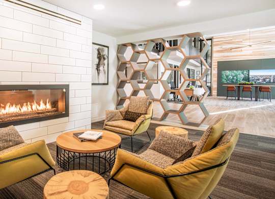 A modern living room with a fireplace and a large abstract art piece on the wall.at Axle, Seattle Washington 