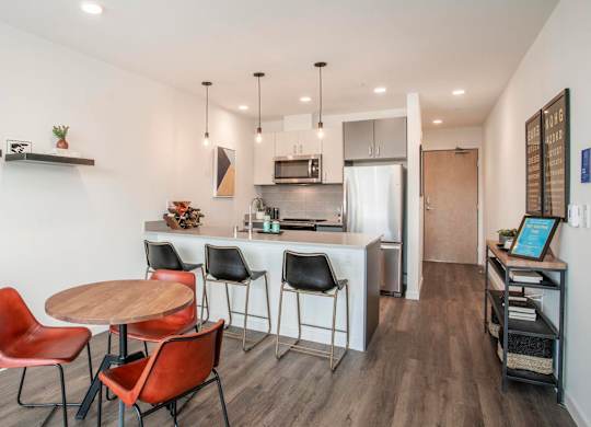 A modern kitchen with a dining table and chairs.at Axle, Seattle Washington 