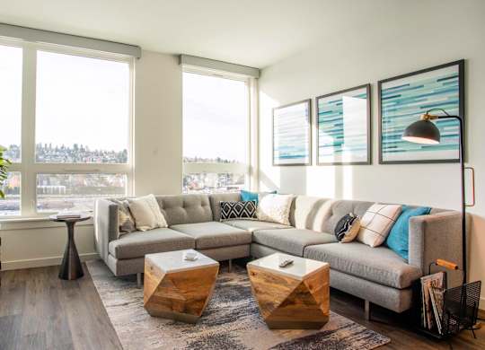 A living room with a grey couch and a wooden coffee table.at Axle, Seattle, WA 98119 