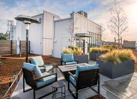 A patio with a table and chairs overlooking a body of water.at Axle, Seattle, WA 