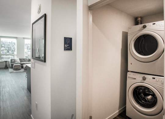 A washer and dryer stacked on top of each other in a small room.at Axle, Washington, 98119