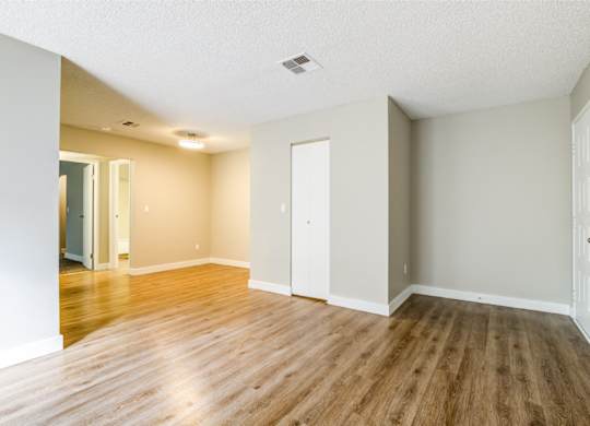 A room with wooden floors and white walls.