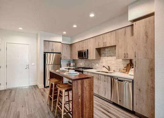 A kitchen with wooden cabinets and a white countertop.