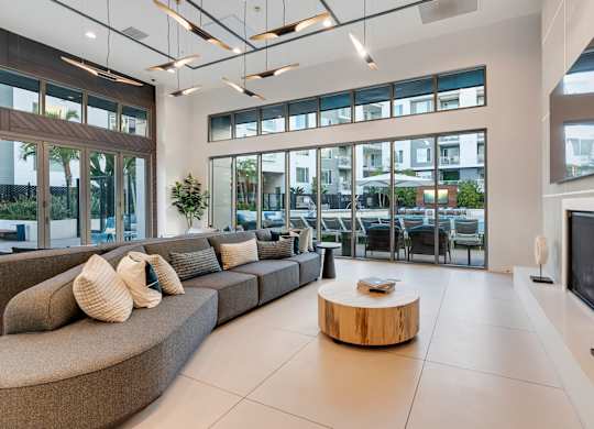 A modern living room with a curved sofa and a coffee table.