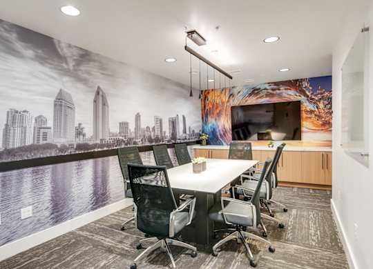 A conference room with a cityscape mural on the wall.