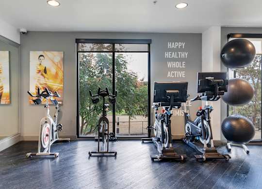 A gym with exercise equipment and a sign that says
