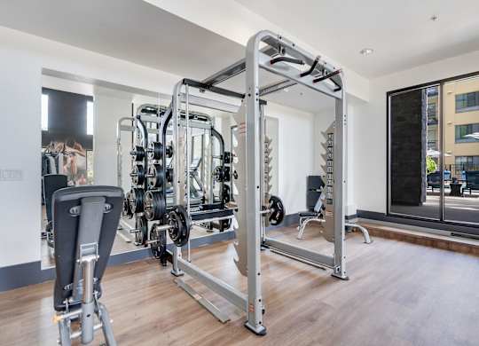 A gym with a variety of equipment including a leg press machine.
