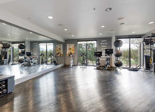 A gym with a variety of equipment and a sign that says
