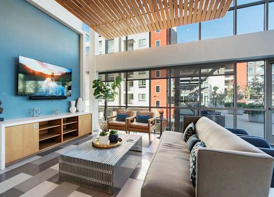 A modern living room with a flat screen TV on the wall.