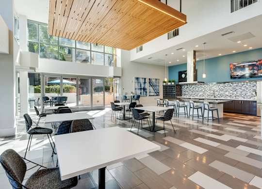 A modern dining room with a white table and chairs.