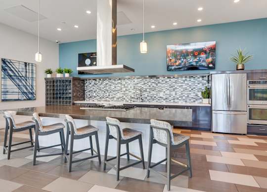 A kitchen with a stone backsplash and a refrigerator.