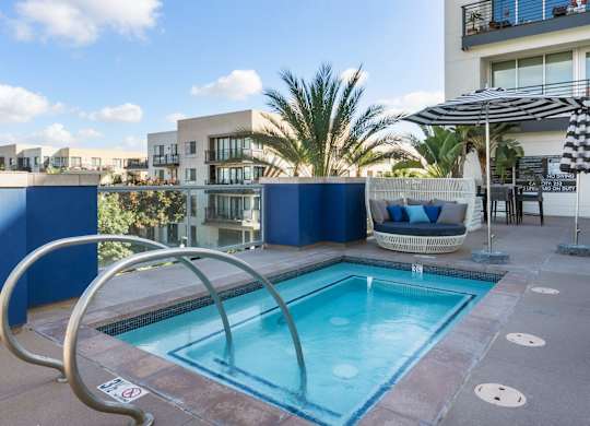 A small pool with a metal railing around it.