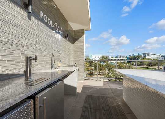 A modern pool club with a view of the pool and the city.