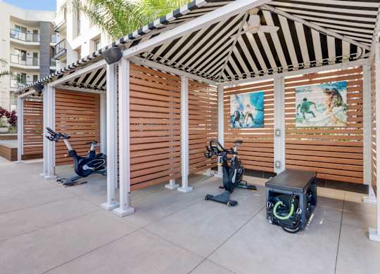 A wooden structure with exercise equipment inside.