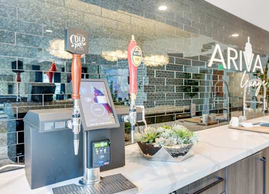 A modern bar with a black and white color scheme and a digital beer tap.