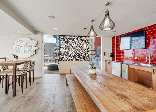 A modern dining area with a wooden table and chairs.