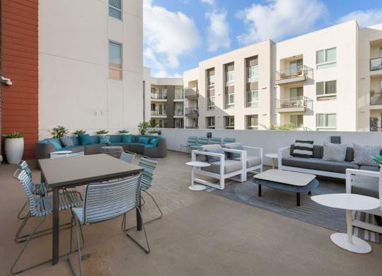 A patio with furniture and a table with a white background.