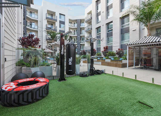 A black and red tire with the number 3 on it sits on a green artificial turf.