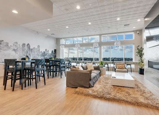 A spacious living room with a city skyline mural on the wall.