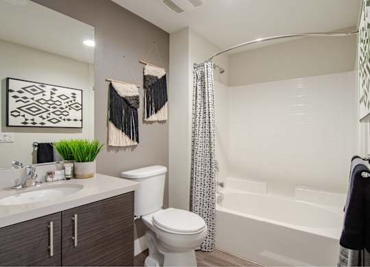 A bathroom with a white toilet, a white sink, and a white bathtub.