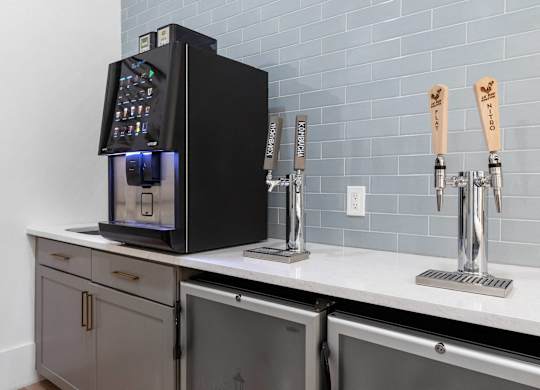 A black coffee machine with a digital display is on a kitchen counter.