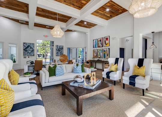 A living room with a white couch and a wooden coffee table.