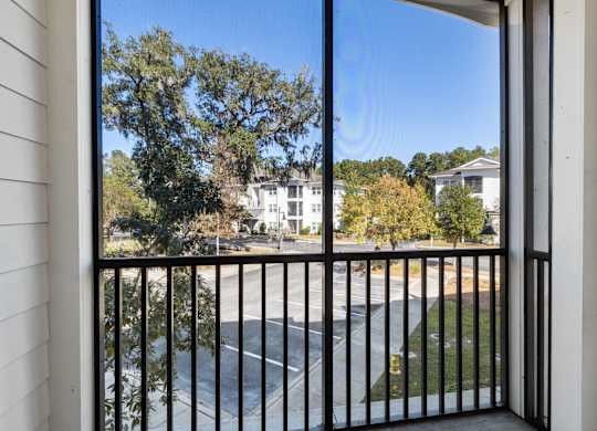 A view from a balcony looking out at a street.