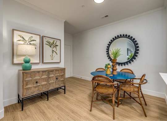 A dining room with a blue table and chairs.