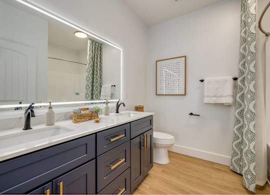 A bathroom with a white sink and a mirror.