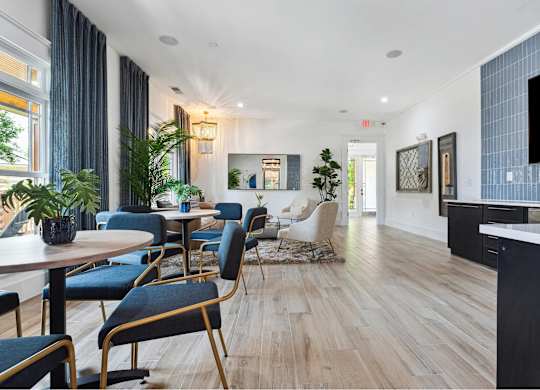 A modern dining room with a long table and chairs.