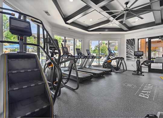 A gym with treadmills, elliptical machines, and a stair climber.