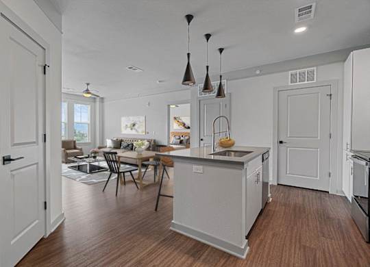 A kitchen with a table and chairs in the middle of the room.