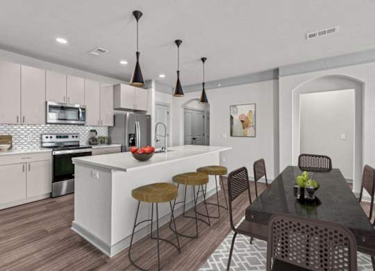 A modern kitchen with a dining table and chairs.