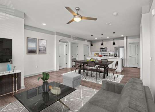 A modern living room with a black coffee table and grey sofa.