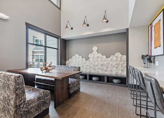 A modern dining room with a wooden table and chairs.
