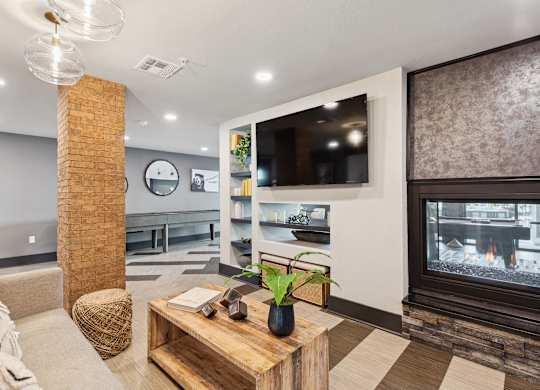 A modern living room with a fireplace and a flat screen TV.