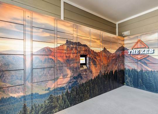 A wall mural of a mountain landscape with a cabin and the text