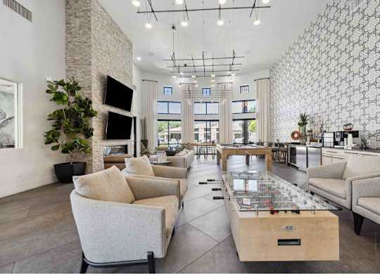 A modern living room with a stone pillar, a glass coffee table, and a patterned wallpaper.