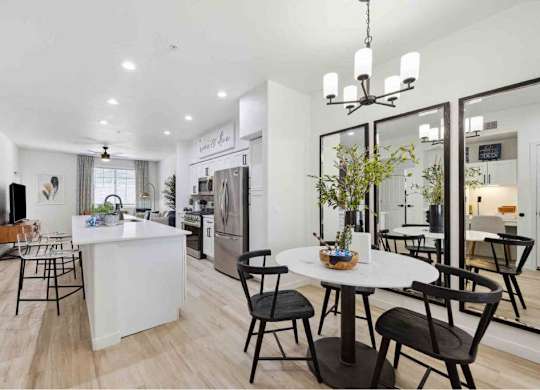A modern kitchen with a dining table set for four.