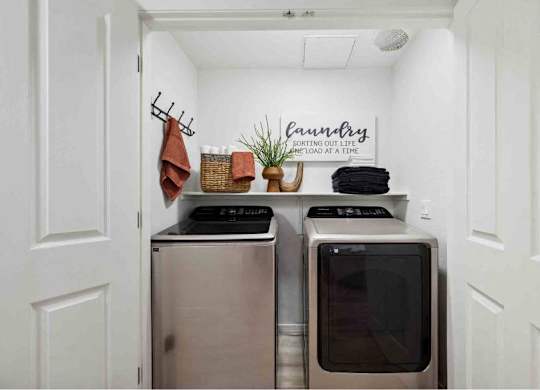 A small laundry room with a washer and dryer.