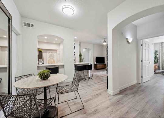 A dining area with a round table and chairs.