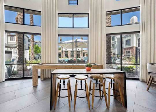 A modern dining area with a long table and chairs.